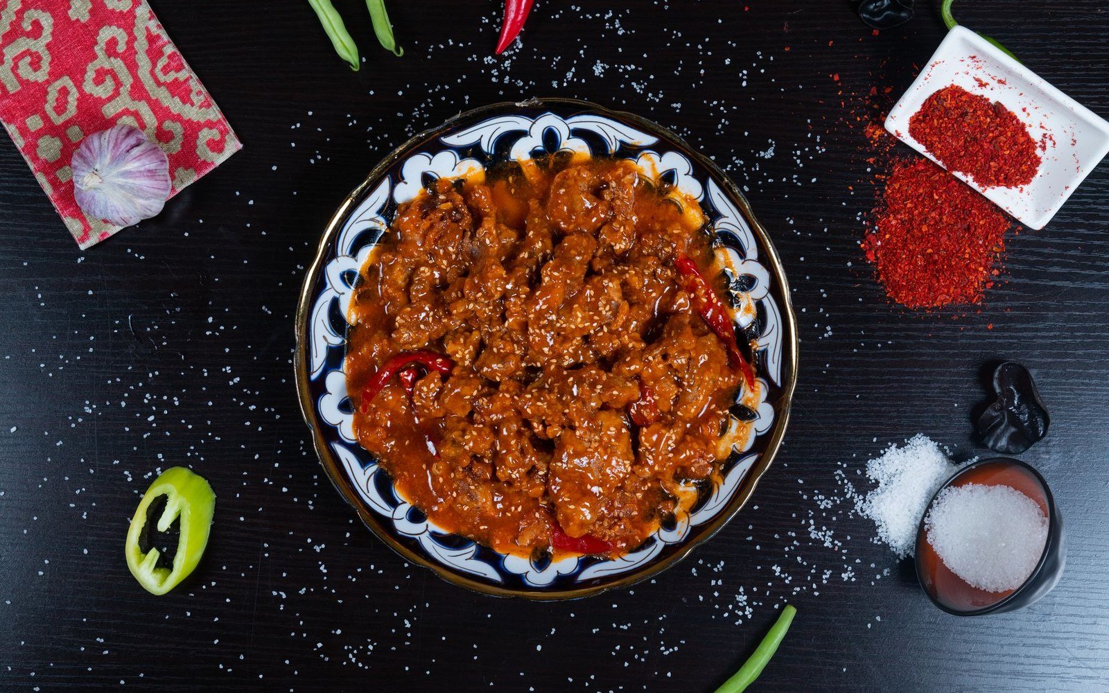 Spicy beef chili con carne with dried red chilies on a patterned plate